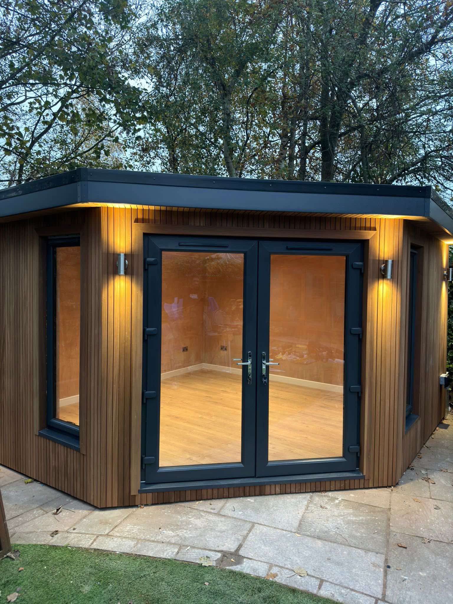 Luxury outdoor living structure with warm evening lighting